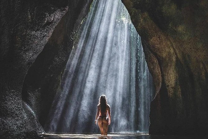 Shafts of sunlight falling into the rock gorge at Tukad Cepung