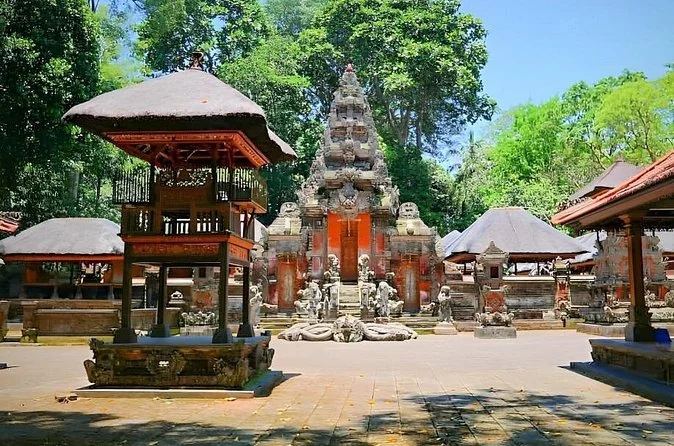 A Balinese temple gate and compound walls beside a road